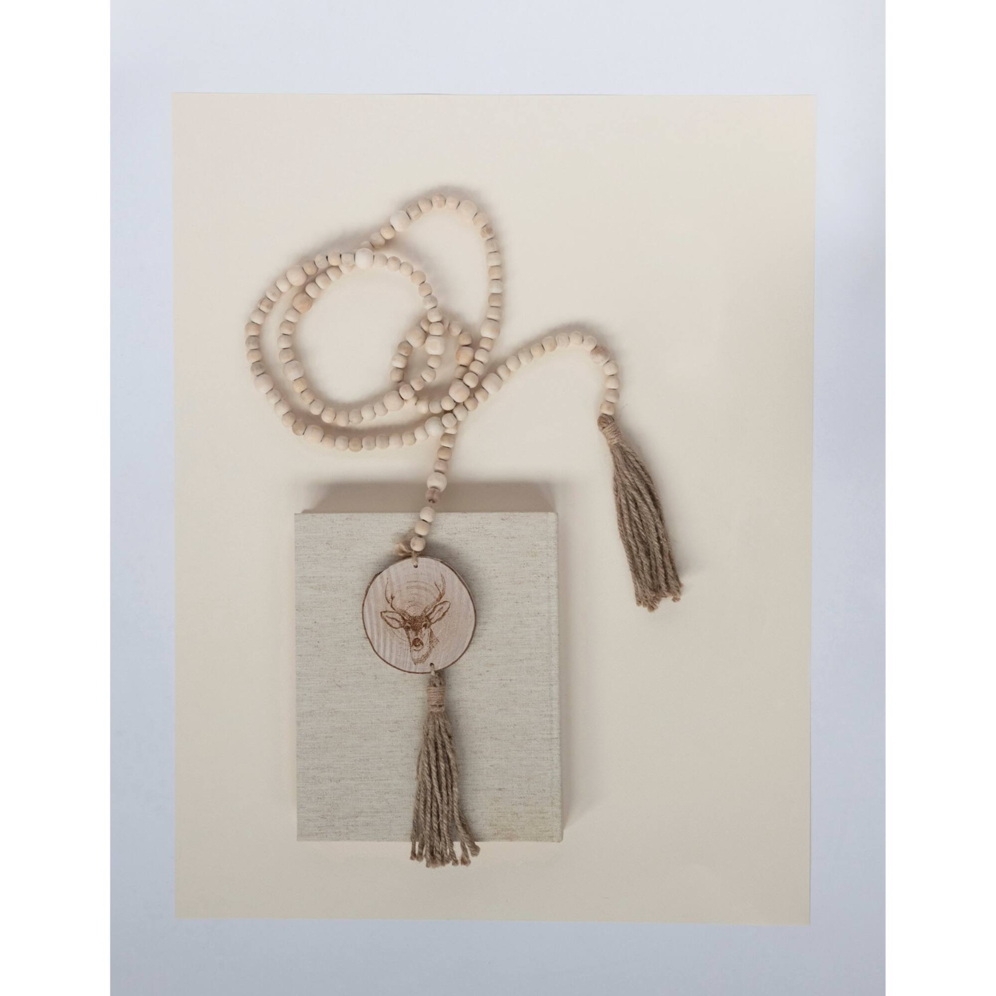 Hello Honey® 6ft. Paulownia Wood Beads with Deer Icons & Tassels Garland